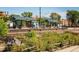Train station view with metal awnings, sunny day, and colorful flowers in the foreground at 8408 W 52Nd Ave, Arvada, CO 80002