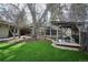 Picturesque backyard featuring a pergola with seating, a lush lawn, and privacy fencing at 1423 S Eudora St, Denver, CO 80222