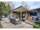 Stylish covered deck with comfortable seating, a dining area, a hot tub, and a well-manicured lawn at 1423 S Eudora St, Denver, CO 80222