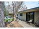Exterior view of the home showing a wooden walkway, backyard with seating, and a well-maintained lawn at 1423 S Eudora St, Denver, CO 80222