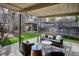 Outdoor living area featuring a covered deck with comfortable seating, a trampoline, and a dining pergola at 1423 S Eudora St, Denver, CO 80222