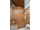 Modern bathroom with a glass-enclosed shower featuring textured brown tile and sleek fixtures at 1423 S Eudora St, Denver, CO 80222