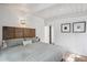 Bright bedroom with a unique headboard, modern lighting and sleek, white walls at 1423 S Eudora St, Denver, CO 80222