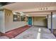 Inviting front entrance with covered carport, wooden ramp, and a vibrant teal door at 1423 S Eudora St, Denver, CO 80222