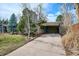 Exterior shot of covered entry and front yard with a small manicured lawn at 1423 S Eudora St, Denver, CO 80222