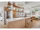 Modern kitchen with wood cabinets, white countertops, open shelving, stainless steel appliances, and light wood floors at 1423 S Eudora St, Denver, CO 80222
