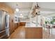 Modern kitchen featuring stainless steel appliances, quartz countertops, and open shelving at 1423 S Eudora St, Denver, CO 80222