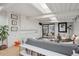 Open living room with hardwood floors, skylights, a gray sofa, built in storage and access to the patio at 1423 S Eudora St, Denver, CO 80222