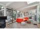 Bright living room with brick flooring, glass doors leading to the outside, and stylish decor at 1423 S Eudora St, Denver, CO 80222