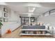 Bright living room featuring hardwood floors, skylights, a gray sofa, and access to the patio at 1423 S Eudora St, Denver, CO 80222