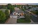 Aerial view of a suburban home with a three-car garage and lush green surroundings at 10701 Flagler Dr, Parker, CO 80134