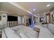 Spacious finished basement boasts an open layout with a large TV, stylish furniture, and modern flooring throughout at 10701 Flagler Dr, Parker, CO 80134