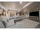 Finished basement features a gray sectional sofa, modern rug, and decorative touches, creating a cozy living space at 10701 Flagler Dr, Parker, CO 80134