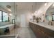 Bright bathroom with a freestanding tub, walk-in shower and double vanity with pendant lighting at 10701 Flagler Dr, Parker, CO 80134