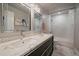 Modern bathroom featuring a double vanity with chrome fixtures, a tub shower, and decorative accents at 10701 Flagler Dr, Parker, CO 80134