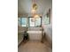 Bright bathroom with a modern soaking tub with bronze fixtures and unique lighting at 10701 Flagler Dr, Parker, CO 80134