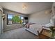 Bright bedroom with a large window providing natural light, modern decor, and neutral colors at 10701 Flagler Dr, Parker, CO 80134