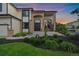 Close-up of a home's entrance with brick accents, a seating area, and manicured landscaping at 10701 Flagler Dr, Parker, CO 80134