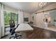 Bright office space with hardwood floors, natural light, and a barn door for added privacy at 10701 Flagler Dr, Parker, CO 80134