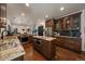 A well-appointed kitchen features stainless appliances, custom cabinetry, granite counters, a center island, and hardwood floors at 10701 Flagler Dr, Parker, CO 80134