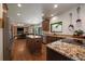 A spacious kitchen features stainless appliances, a center island, hardwood floors, and an open view to the adjacent living space at 10701 Flagler Dr, Parker, CO 80134