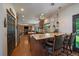 A gourmet kitchen featuring a center island with bar seating, granite countertops, stainless appliances, and hardwood floors at 10701 Flagler Dr, Parker, CO 80134