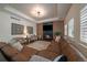 Comfortable living room with a fireplace, large brown sofa, and stylish decor and a tray ceiling at 10701 Flagler Dr, Parker, CO 80134