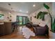 A spacious living room with hardwood floors, a decorative rug, access to the backyard, and a stylish bar with marble counters at 10701 Flagler Dr, Parker, CO 80134
