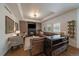 A cozy living room with a fireplace, modern decor, plantation shutters, hardwood floors, and comfortable seating at 10701 Flagler Dr, Parker, CO 80134