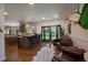 A spacious living room with hardwood floors, a decorative rug, access to the backyard, and a stylish bar with marble counters at 10701 Flagler Dr, Parker, CO 80134