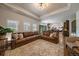 Spacious living room with a large sectional sofa, neutral rug, and direct access to the kitchen at 10701 Flagler Dr, Parker, CO 80134