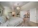 Inviting main bedroom with a view into the main bathroom and a carpeted floor at 10701 Flagler Dr, Parker, CO 80134