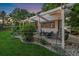 Outdoor patio featuring a pergola, string lights, chairs, and well-manicured landscaping at 10701 Flagler Dr, Parker, CO 80134