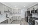Stylish kitchen with gray cabinetry, stainless steel appliances, and modern backsplash at 2203 S Holly St # 3, Denver, CO 80222