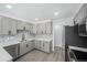 Modern kitchen with gray cabinetry, stainless steel appliances, and backsplash design at 2203 S Holly St # 3, Denver, CO 80222