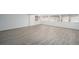 Bright living room featuring gray wood flooring and natural light from multiple windows at 2203 S Holly St # 3, Denver, CO 80222