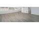 Bright living room featuring gray wood flooring and large windows for natural light at 2203 S Holly St # 3, Denver, CO 80222