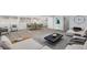 Sunlit living and dining area with modern decor and stylish gray wood flooring at 2203 S Holly St # 3, Denver, CO 80222