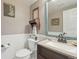 Charming powder room featuring classic fixtures, wainscoting, and decorative mirror at 28700 E 160Th Pl, Brighton, CO 80603
