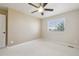 Bright bedroom features neutral paint, a ceiling fan, and a window with lovely views at 28700 E 160Th Pl, Brighton, CO 80603
