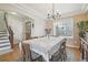 Cozy dining room with natural light, chandelier, wood floors and adjacent staircase at 28700 E 160Th Pl, Brighton, CO 80603