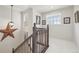 Bright upstairs hallway featuring new carpet, charming decor, and natural light at 28700 E 160Th Pl, Brighton, CO 80603