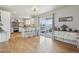 Bright kitchen featuring white cabinetry, an island with seating, stainless steel appliances, and deck access at 28700 E 160Th Pl, Brighton, CO 80603