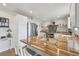 Well-lit kitchen with wood counters, stainless steel appliances, and an island with bar seating at 28700 E 160Th Pl, Brighton, CO 80603