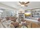 Cozy living room with a stone fireplace, plush seating, and natural light from large windows at 28700 E 160Th Pl, Brighton, CO 80603
