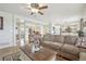 Open-concept living room with hardwood floors, comfortable seating, and seamless flow into the dining and kitchen areas at 28700 E 160Th Pl, Brighton, CO 80603