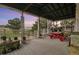 Spacious covered porch with a red picnic table, lovely views, and plenty of space for entertaining at 28700 E 160Th Pl, Brighton, CO 80603