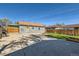 Backyard view showcasing a spacious concrete area, partial grass, and a wooden fence for privacy at 2080 S King St, Denver, CO 80219