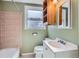 Cozy bathroom with beige tile, white vanity, and a shower-tub combination for convenience at 2080 S King St, Denver, CO 80219