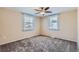 Comfortable bedroom featuring neutral walls, plush carpeting, and natural light from two windows at 2080 S King St, Denver, CO 80219